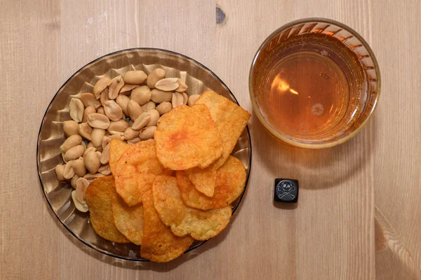 Unhealthy snacks on table with skull dice
