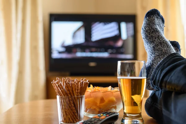 Television, TV watching (movie) with feet on table and huge amou