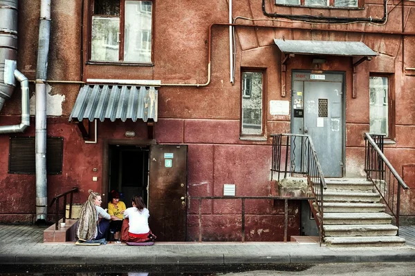 Women sitting in the backyard of the house