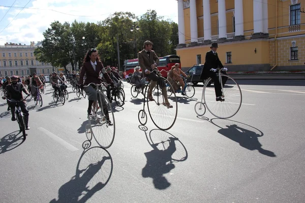 People riding bikes during Tweed Run in St. Petersburg