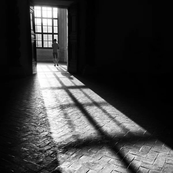 Shadow at floor and man near big window