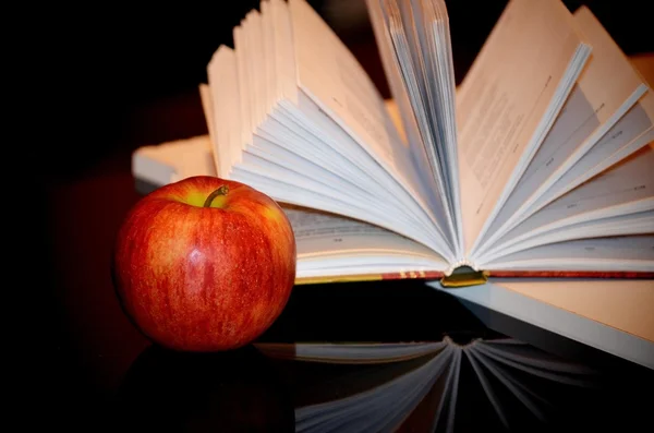 Red apple and open book