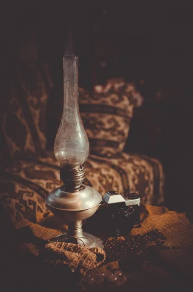 Old camera, coffee beans and kerosene lamp