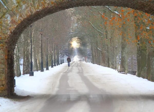 Man walking down the road with tunnels