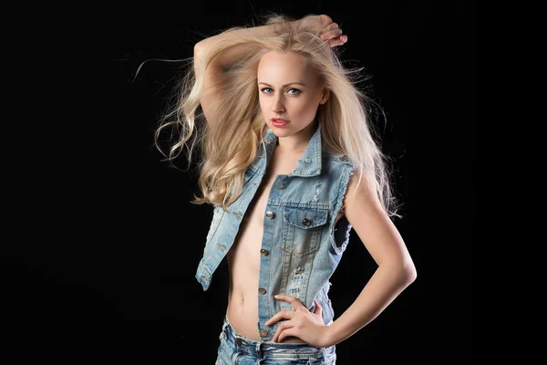 Blonde woman in jeans wear with windy hair
