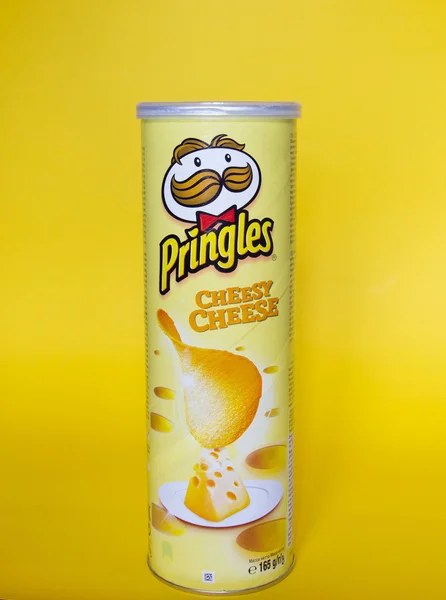 A can of Pringles Cheddar Cheese chips on yellow background