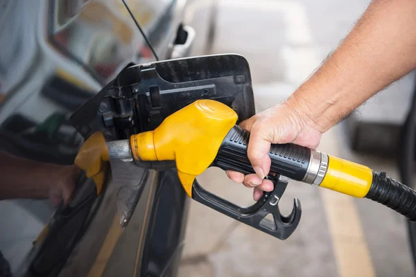 Man pumping fuel in car