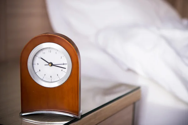 Alarm-clock in morning bedroom