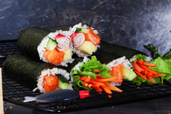 Roll sushi black background different tastes, crab, carrots, lettuce, tofu, salmon, still life, home, stylish, wooden worktops