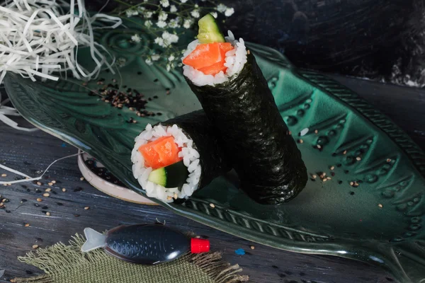 Roll with salmon nori style, black background, still life, close up, fast food