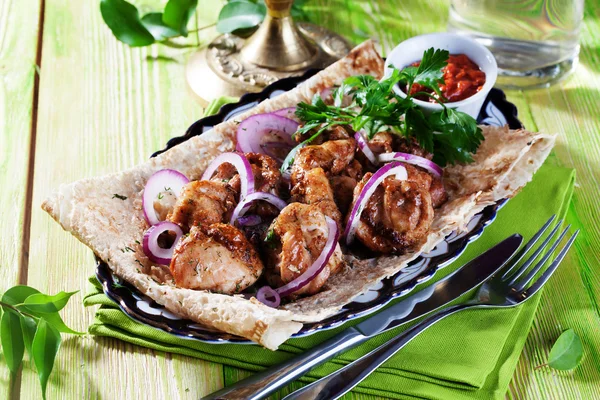 Skewers with red onion thin pita bread still life green wooden boards, atmosphere restaurant