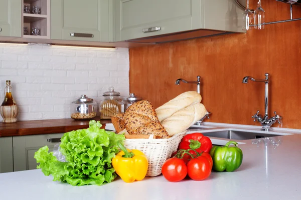 Kitchen design light fresh vegetables, bread basket, lettuce, peppers, tomatoes, shopping, cooking two sinks with faucets Bank pasta table