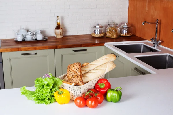 Kitchen design light fresh vegetables, bread basket, lettuce, peppers, tomatoes, shopping, cooking two sinks with faucets Bank pasta table