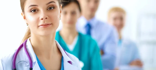 Attractive female doctor in front of medical group