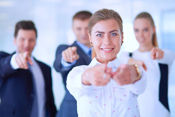 Group of business people pointing to you