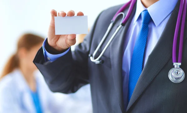 Male doctor holding blank  white card