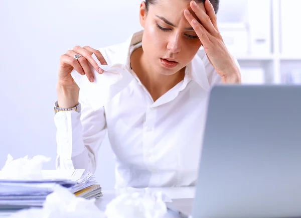 Stressed businesswoman sitting at desk in the office