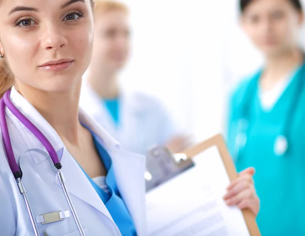 Attractive female doctor in front of medical group