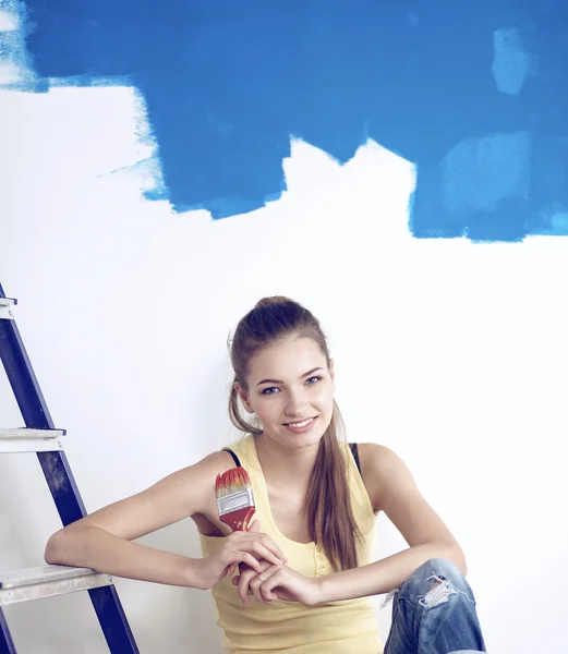 Portrait of happy smiling young couple  painting interior wall of new house