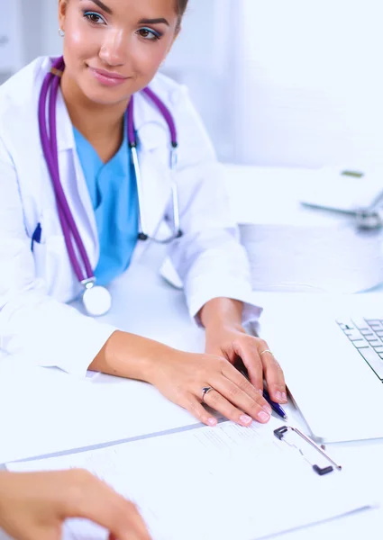 Doctor and patient sitting on the desk  at office