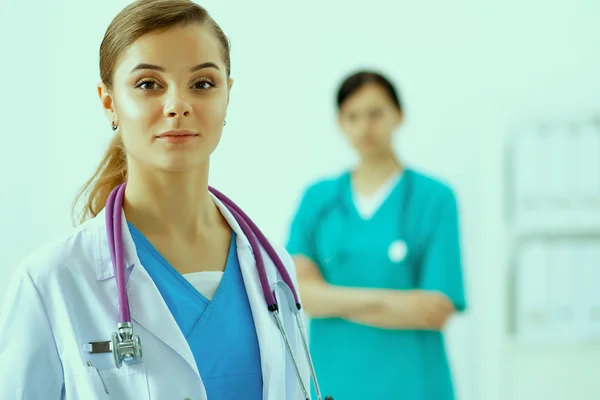 Attractive female doctor in front of medical group