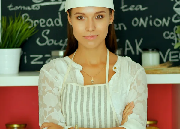 Chef woman portrait with uniform in the kitchen