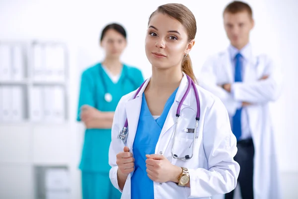 Attractive female doctor in front of medical group