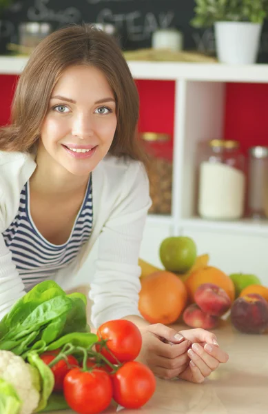 Young woman sitting near desk in the kitchen