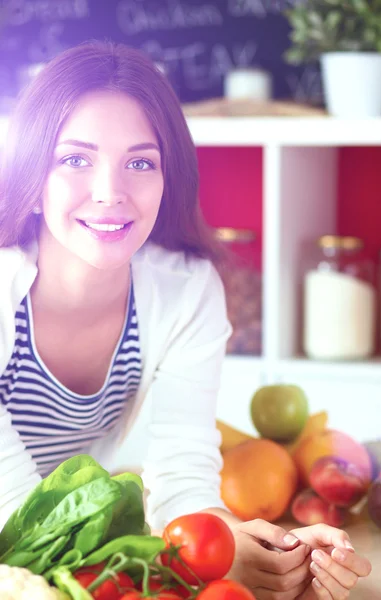 Young woman sitting near desk in the kitchen