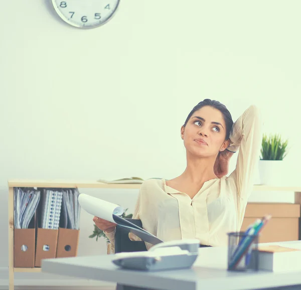 Business woman  relaxing with  hands behind her head and sitting on an office chair