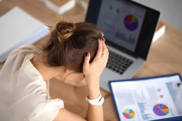 Young and beautiful businesswoman tired from work in the office