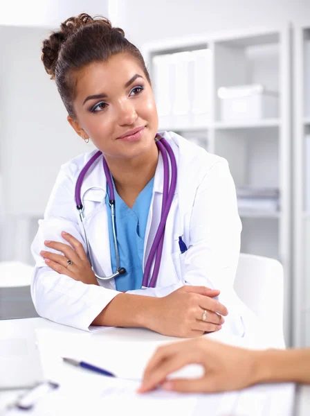 Doctor and patient sitting on the desk at office