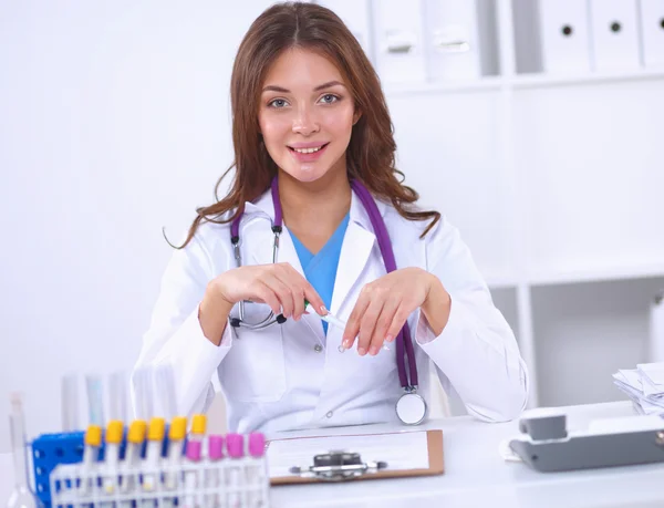 Woman researcher is surrounded by medical vials and flasks, isolated on white background