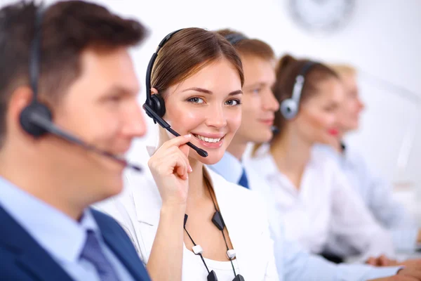 Attractive Smiling positive young businesspeople and colleagues in a call center office