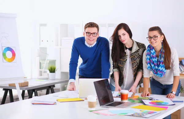 Young business people standing at office near desk
