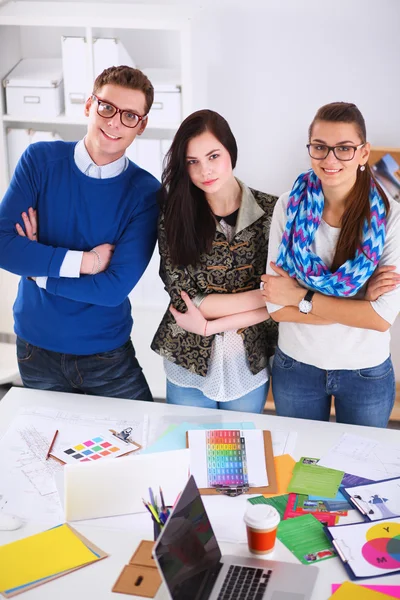 Young business people standing at office near desk