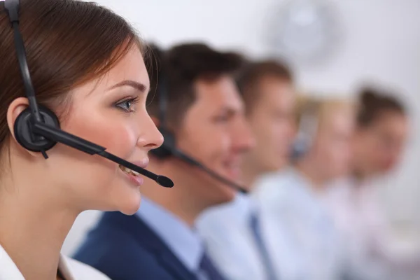 Attractive positive young businesspeople and colleagues in a call center office