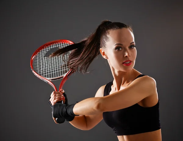 Female tennis player with racket ready to hit a tennis
