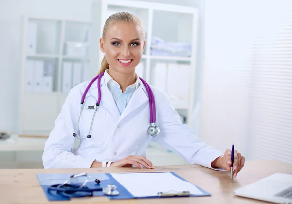 Medical team sitting at the table in modern hospital