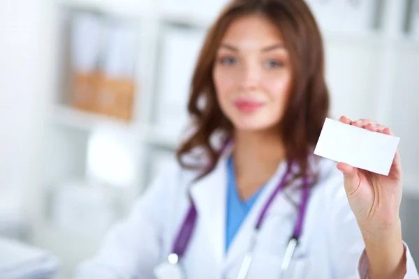 Female doctor holding an empty card, isolated on white background