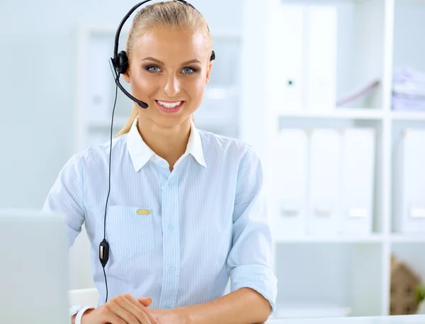 Close-up portrait of a customer service agent sitting at office