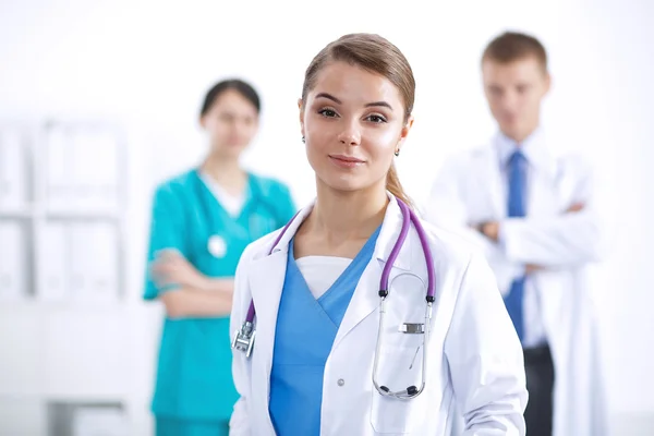 Attractive female doctor in front of medical group