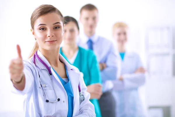 Attractive female doctor in front of medical group