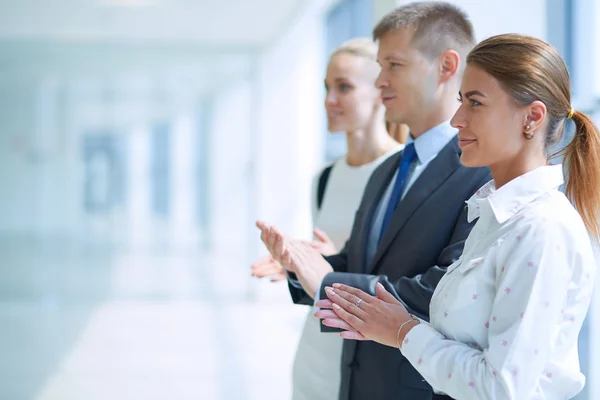 Smiling business people applauding a good presentation in the office