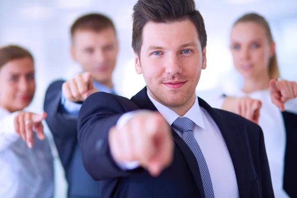 Group of business people pointing to you