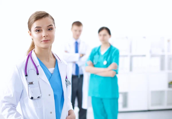 Attractive female doctor in front of medical group