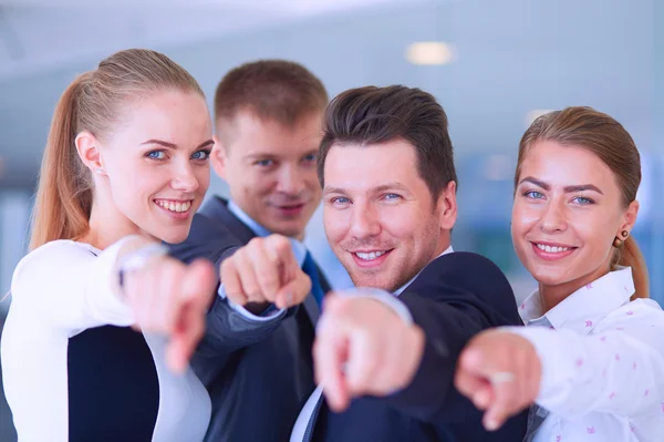 Group of business people pointing to you