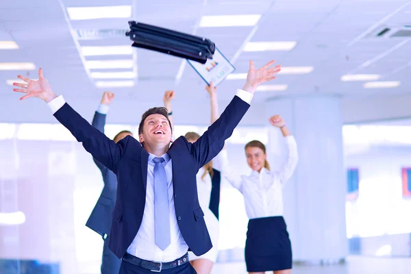 Business team celebrating a triumph with arms up