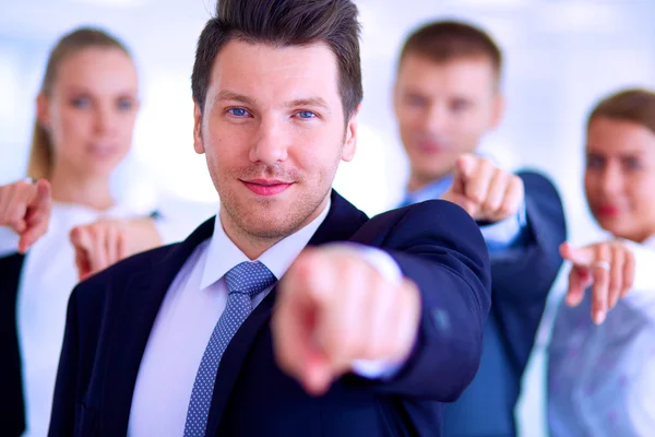 Group of business people pointing to you