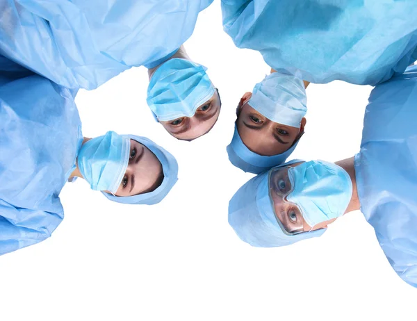 Surgeons team, wearing protective uniforms,caps and masks